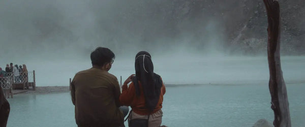 Two people watching Kawa Putih in Ciwidey, near Bandung, West Java, Indonesia