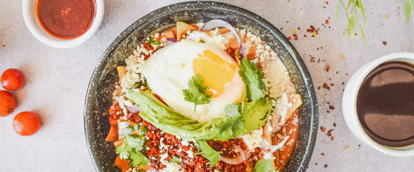 A bowl of Chilaquiles Rojos, a traditional Mexican breakfast dish