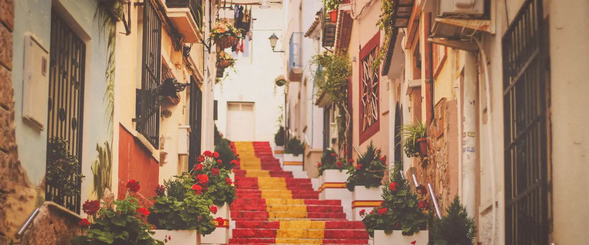 Concrete stairs painted in the colors of the Spanish flag, in the Old Town of Calp, in Spain