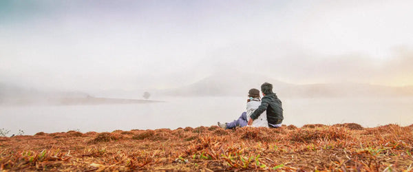 A couple sat looking across the landscape in the highlands of Da Lat, Vietnam