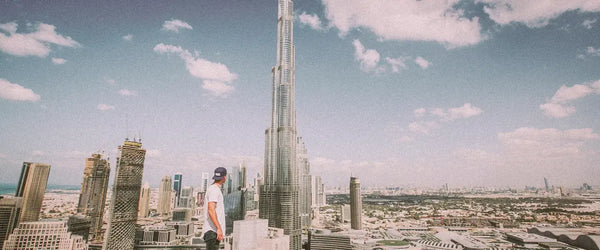 Someone looking up at the Burj Khalifa in Dubai and the city beyond