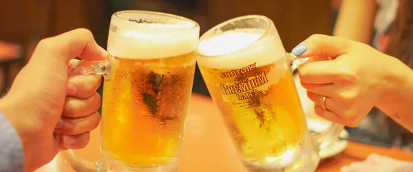Two people clinking beer steins