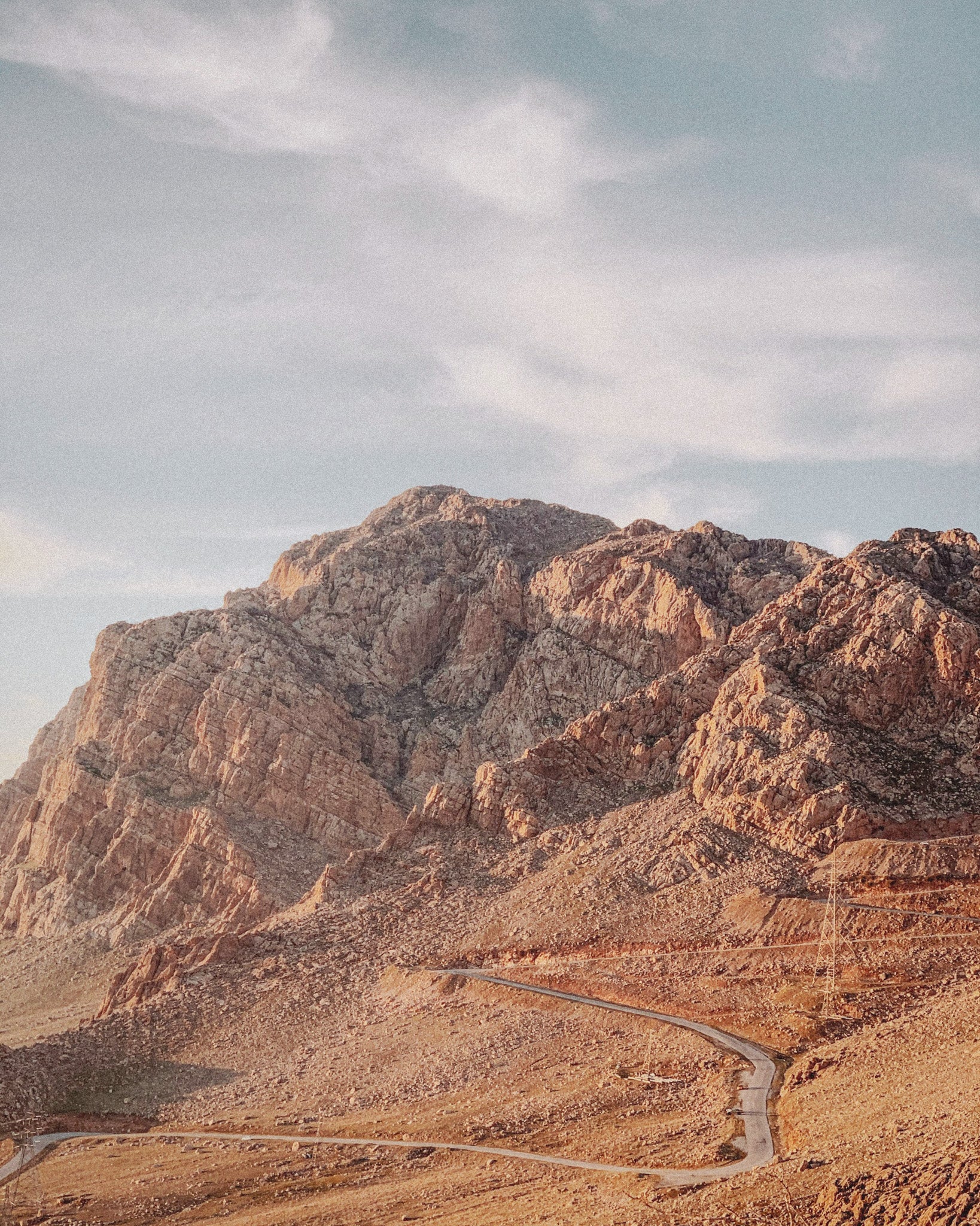 Iraq landscape of winding road in Arid Mountains, promoting eSIM service