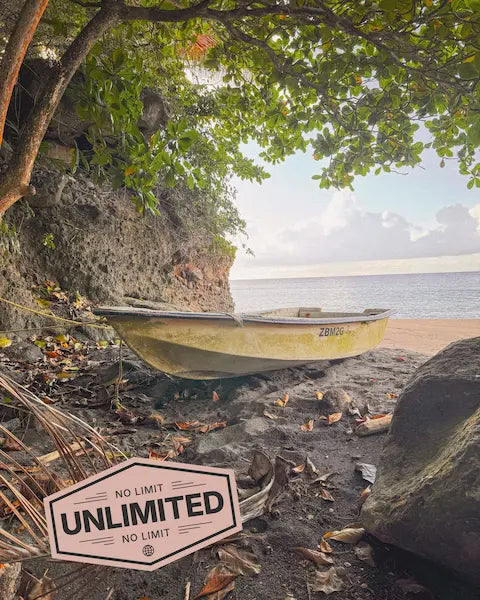 Beach scene with a boat and 'No Limit Unlimited' sign, promoting SIMOVO eSIM for Montserrat 